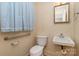 Small bathroom with a toilet, sink, and grab bar at 422 Roselawn Pl, Charlotte, NC 28211