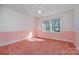 Bedroom with pink walls, carpet, and a ceiling fan at 422 Roselawn Pl, Charlotte, NC 28211