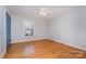 Bedroom with hardwood floors, window with shutters, and ceiling fan at 422 Roselawn Pl, Charlotte, NC 28211