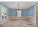 Dining room with light blue walls and a chandelier at 422 Roselawn Pl, Charlotte, NC 28211