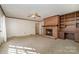 Living room with a brick fireplace and built-in shelving at 422 Roselawn Pl, Charlotte, NC 28211