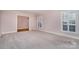 Neutral-toned living room with hardwood floors and access to another room at 422 Roselawn Pl, Charlotte, NC 28211