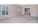 Spacious living area with neutral walls and carpeting, leading to the dining room at 422 Roselawn Pl, Charlotte, NC 28211