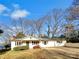 Ranch home with a large yard, driveway and mature trees at 502 Cherry St, Belmont, NC 28012