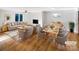 Virtually staged living room with hardwood floors, dining area and fireplace at 502 Cherry St, Belmont, NC 28012