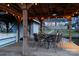 Waterfront property with a covered deck, string lights, and views of the lake and house at 680 Lake Head Rd, Norwood, NC 28128