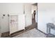 Hallway with a peek into the bright kitchen, featuring modern finishes at 680 Lake Head Rd, Norwood, NC 28128