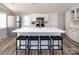 Bright kitchen features a large island with seating, white cabinetry, stainless steel appliances, and modern finishes at 680 Lake Head Rd, Norwood, NC 28128