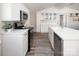 Stylish kitchen showcasing white cabinets, stainless steel appliances, and a colorful rug on wood-look floors at 680 Lake Head Rd, Norwood, NC 28128