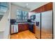 Modern kitchen features stainless steel appliances and wood cabinets at 716 N Alexander St, Charlotte, NC 28202