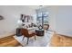 Bright living room with hardwood floors, stylish furniture, and large windows at 716 N Alexander St, Charlotte, NC 28202