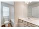 Bathroom with single vanity, bathtub, and window for natural light at 7220 Hodges Meadow Ln, Charlotte, NC 28213