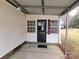 Inviting front porch with black metal door and covered entryway at 796 S Lincoln S St, Dallas, NC 28034