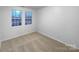 Well-lit bedroom with neutral walls and carpet at 8249 Chatham Oaks Dr, Concord, NC 28027