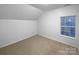 Bright bedroom featuring neutral wall and carpet colors at 8249 Chatham Oaks Dr, Concord, NC 28027