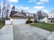 House exterior showing driveway and landscaping at 8249 Chatham Oaks Dr, Concord, NC 28027