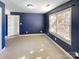 Finished basement room with blue walls and carpet at 8806 Glenside St, Huntersville, NC 28078