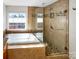 Elegant bathroom with soaking tub and a frameless shower at 8806 Glenside St, Huntersville, NC 28078