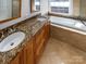 Bathroom with double vanity, granite countertop and soaking tub at 8806 Glenside St, Huntersville, NC 28078