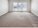 Spacious bedroom with neutral carpeting and large windows at 8806 Glenside St, Huntersville, NC 28078