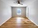 Light-filled bedroom with hardwood floors and a ceiling fan at 8806 Glenside St, Huntersville, NC 28078