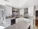 Modern kitchen with white cabinets, quartz countertops, and stainless steel appliances at 8806 Glenside St, Huntersville, NC 28078