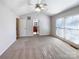 Bright main bedroom with ceiling fan, carpet, and en-suite bathroom at 8806 Glenside St, Huntersville, NC 28078