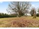 Large backyard with a leafless tree and a view of the water at 912 Hickory Grove Rd, Gastonia, NC 28056