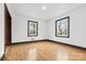 Traditional style bedroom with hardwood floors and two windows with black trim at 912 Hickory Grove Rd, Gastonia, NC 28056