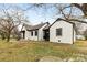 Charming exterior of a white brick home with black trim, walkways, and tidy lawn at 912 Hickory Grove Rd, Gastonia, NC 28056