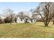 Charming exterior of a white brick home with black trim on a large lot at 912 Hickory Grove Rd, Gastonia, NC 28056