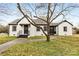 Charming exterior of a white brick home with black trim and a walkway at 912 Hickory Grove Rd, Gastonia, NC 28056