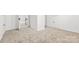 Hallway with neutral carpet leads to a doorway, door, and stairs at 912 Hickory Grove Rd, Gastonia, NC 28056