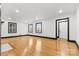 Bright living room featuring hardwood floors, white walls, and fireplace at 912 Hickory Grove Rd, Gastonia, NC 28056