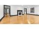 Spacious living room featuring hardwood floors, white walls, and fireplace at 912 Hickory Grove Rd, Gastonia, NC 28056