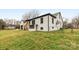 Exterior side and rear view of white brick home featuring black trim and detached garage at 912 Hickory Grove Rd, Gastonia, NC 28056