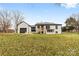 Exterior rear view of white brick home featuring black trim and detached garage at 912 Hickory Grove Rd, Gastonia, NC 28056