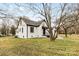 Exterior side view of white brick home featuring black trim and landscaped yard at 912 Hickory Grove Rd, Gastonia, NC 28056