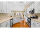 Open concept kitchen with white cabinets and stainless steel appliances at 9813 Hanberry Blvd, Charlotte, NC 28213