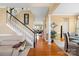 Elegant staircase with black railing and hardwood floors at 9813 Hanberry Blvd, Charlotte, NC 28213