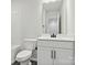 A well-lit bathroom featuring a toilet, sink, and cabinet at 10121 Mamillion Dr, Huntersville, NC 28078