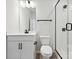 Well-lit bathroom with white vanity, toilet, and a glass-enclosed shower with black hardware at 10121 Mamillion Dr, Huntersville, NC 28078