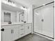 Modern bathroom featuring dual vanity sinks, a large mirror, and a glass-enclosed shower at 10121 Mamillion Dr, Huntersville, NC 28078
