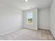 Bright bedroom featuring a neutral carpet and a window at 10121 Mamillion Dr, Huntersville, NC 28078