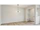 Bright dining area featuring modern lighting and laminate wood floors at 10121 Mamillion Dr, Huntersville, NC 28078