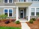 Inviting front porch featuring stone accents and a contemporary front door at 10121 Mamillion Dr, Huntersville, NC 28078