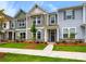 Charming townhome with manicured lawn, stone accents, and inviting entryway at 10121 Mamillion Dr, Huntersville, NC 28078