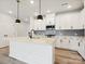 Gorgeous kitchen island with stainless steel appliances and stylish pendant lights at 10121 Mamillion Dr, Huntersville, NC 28078