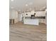 Spacious living area featuring an open floor plan with sight lines into the kitchen and access to the staircase at 10121 Mamillion Dr, Huntersville, NC 28078