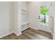 Mud room with built-in storage bench and shelves, and a door leading to the outside at 10121 Mamillion Dr, Huntersville, NC 28078